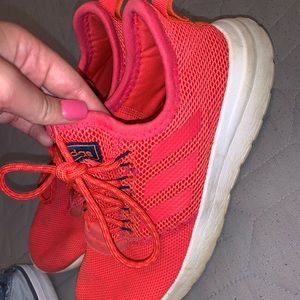 Bright pinkish red adidas shoes